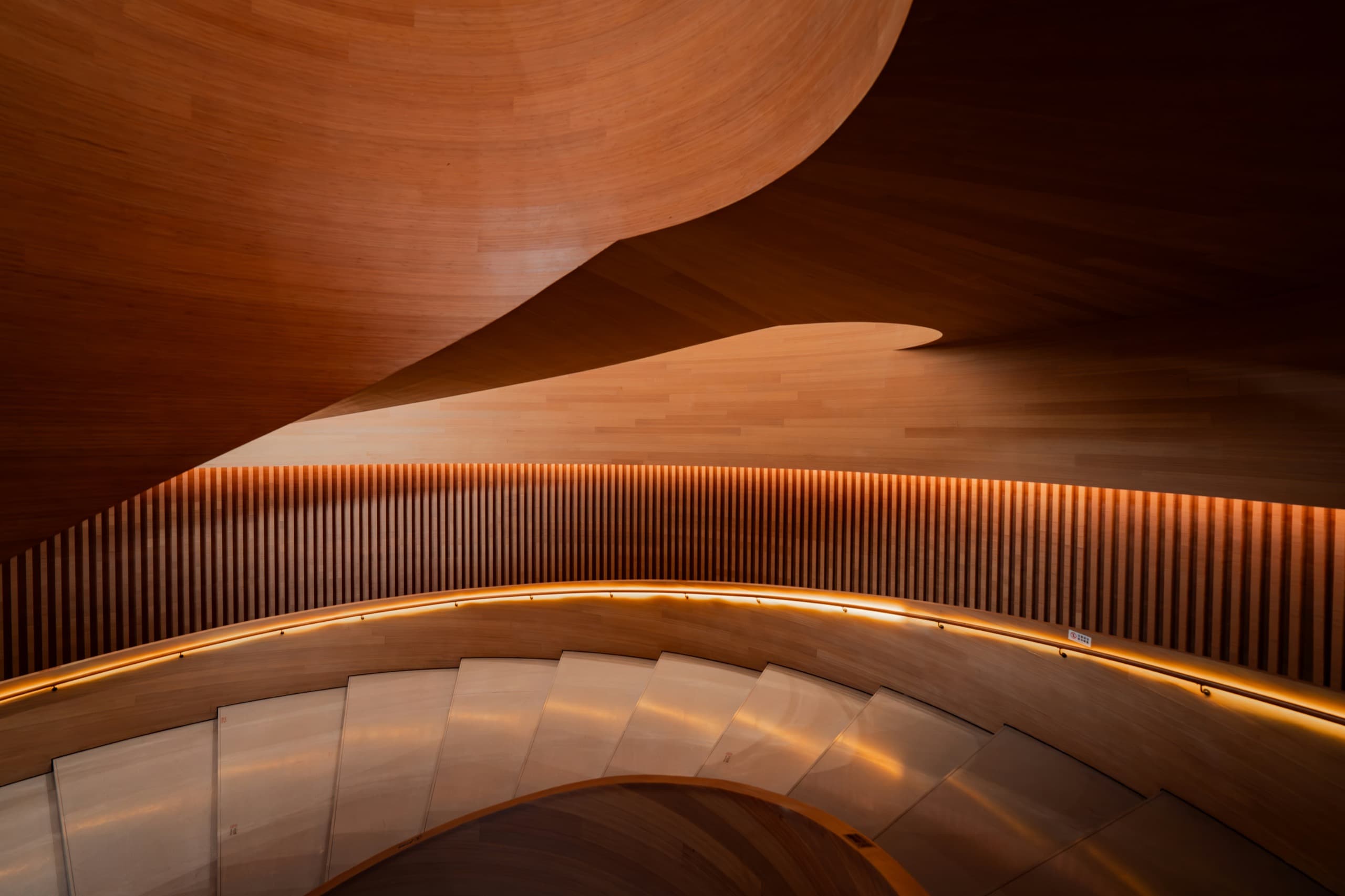 Curved wood staircase in a commercial interior
