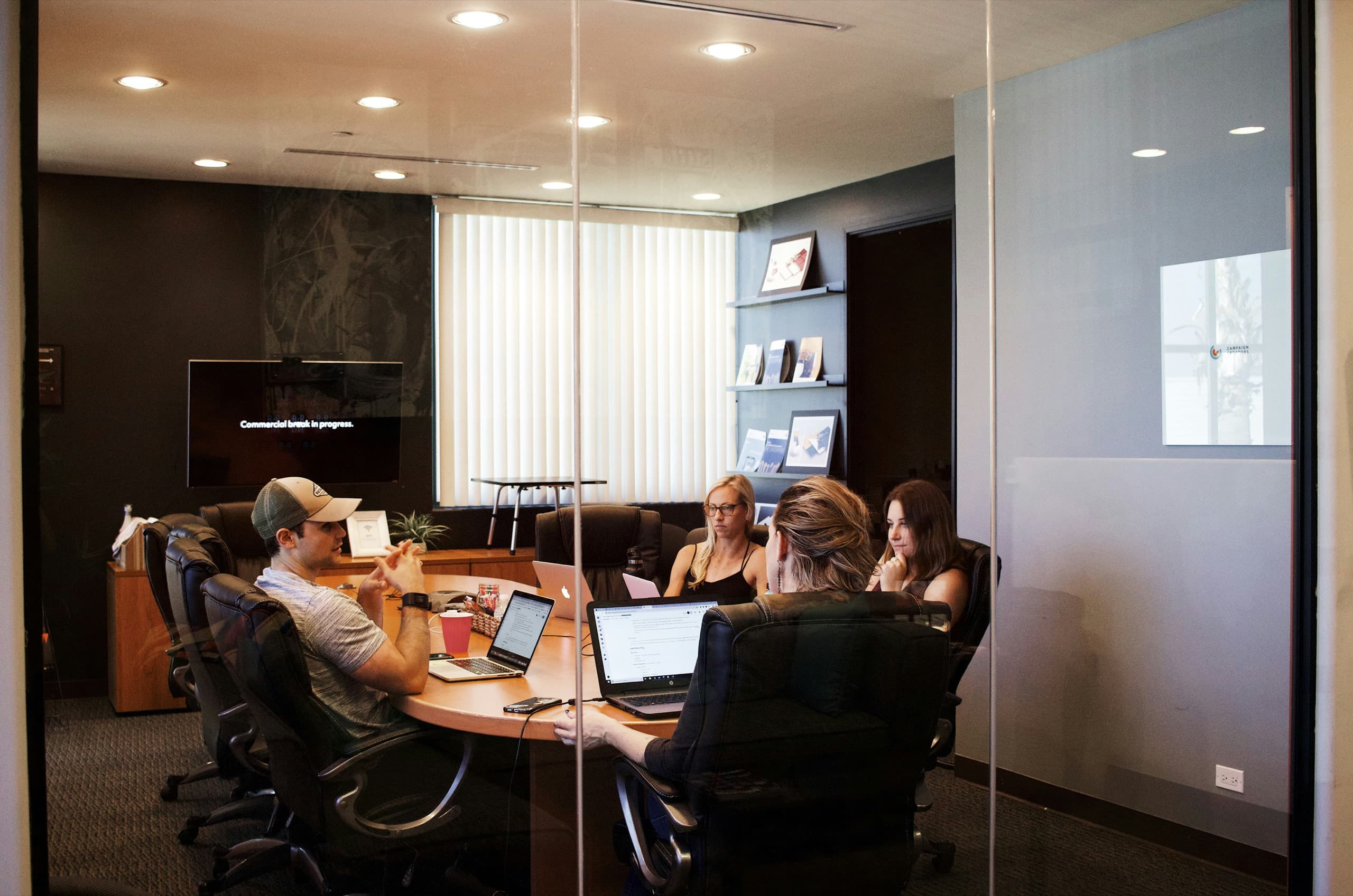 OneSpace team members meeting around a table