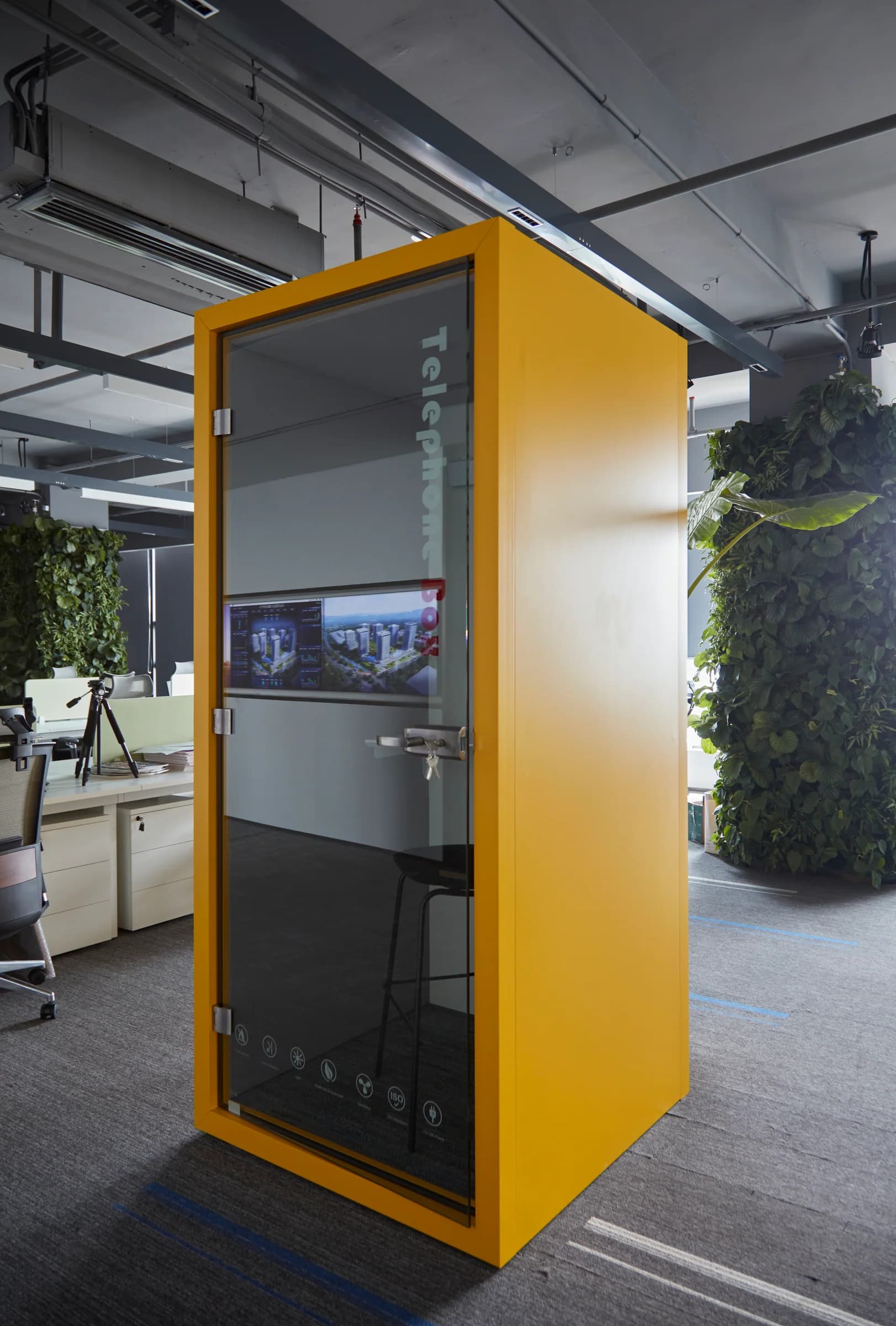 Bright yellow acoustic office pod in the open workplace