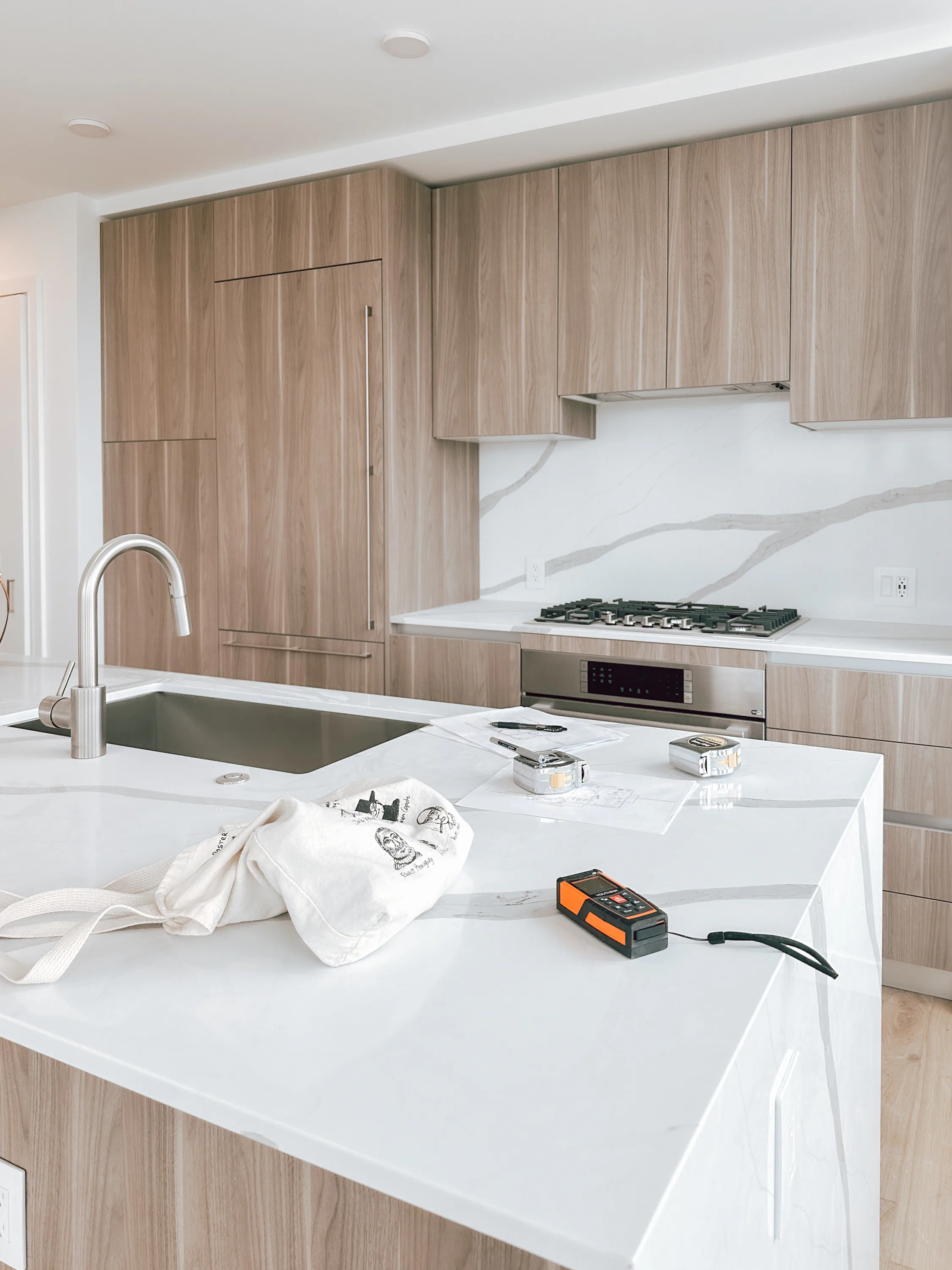 OneSpace team measuring a model residence before production