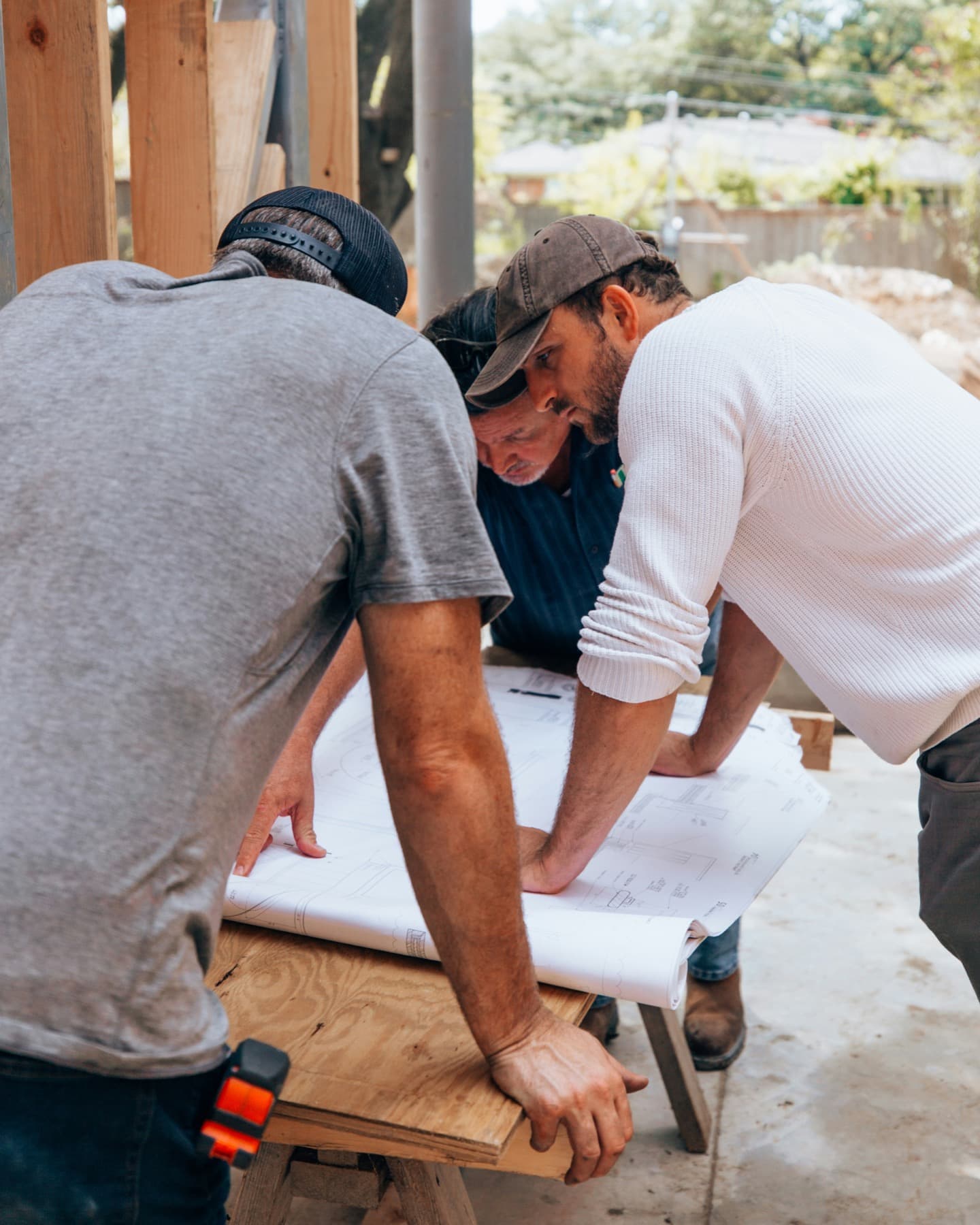 Project team reviewing construction drawings on site