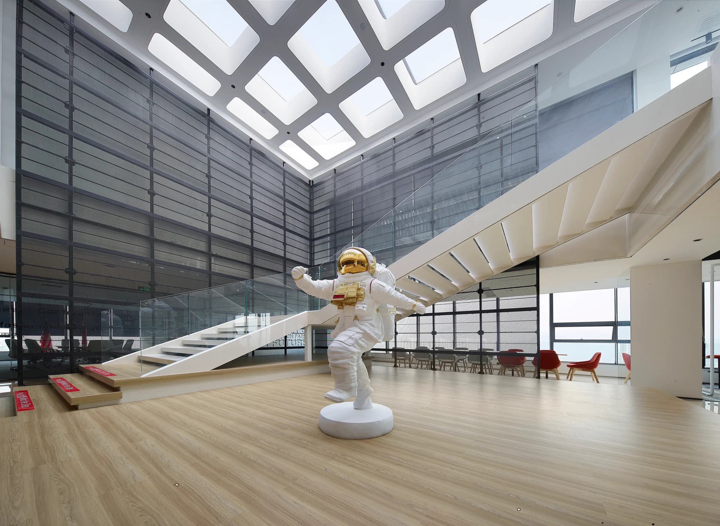 Large shared hall with an astronaut sculpture and broad stair