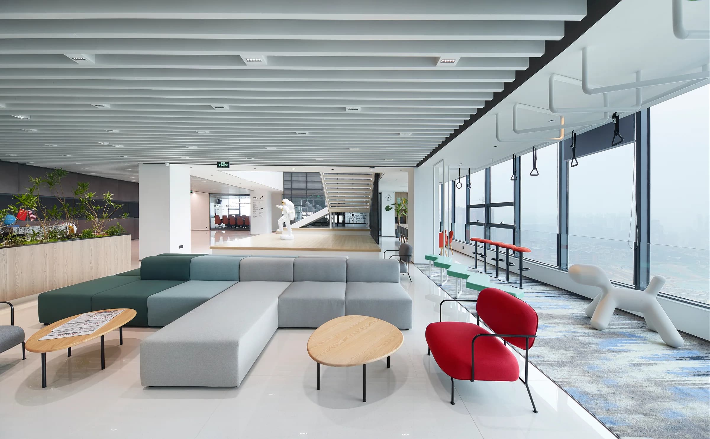 Grand Tech Park lobby with modular seating, greenery, and city views